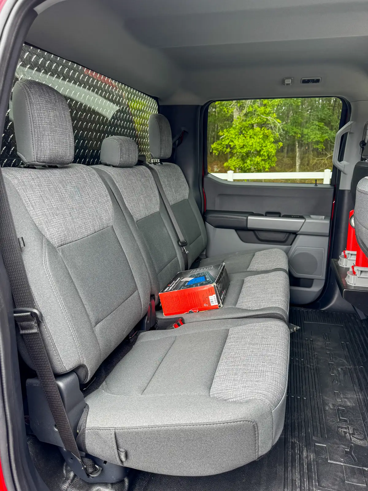 Side door open interior view showing access path to the rear bench seat.